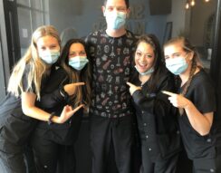 A group of people wearing masks and pointing at each other