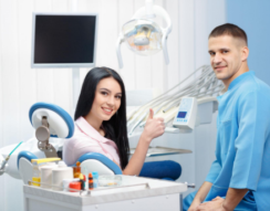 A patient and orthodontist smiling in a dental office, showcasing Invisalign treatment